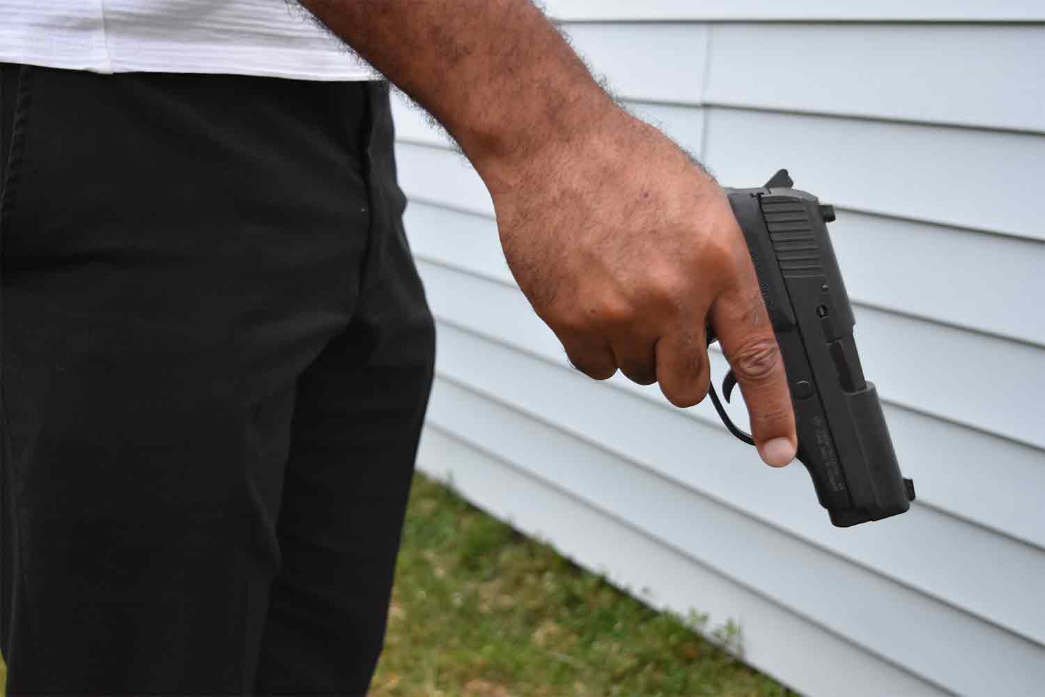 Police Officer holding handgun pistol