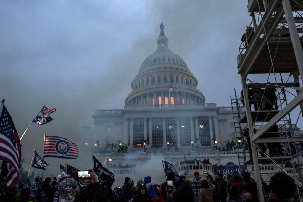 Security forces respond with tear gas after the US President...