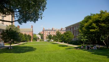 Students relaxing on grass on campus of Brown University, Providence, Rhode Island