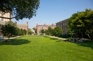 Students relaxing on grass on campus of Brown University, Providence, Rhode Island